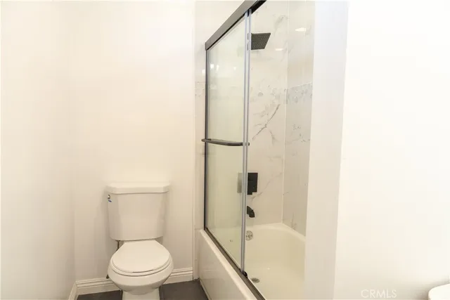 a white toilet sitting next to a bathroom sink