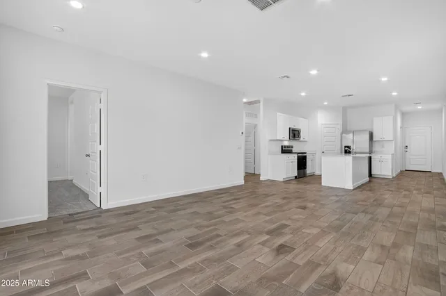 a view of kitchen with refrigerator and window