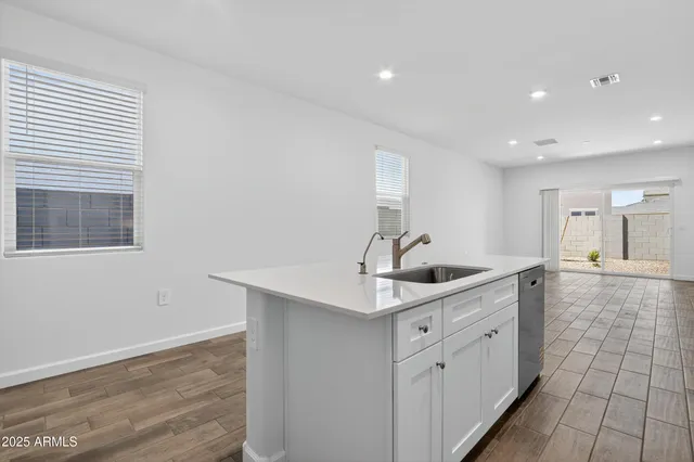 a kitchen with a sink cabinets and window