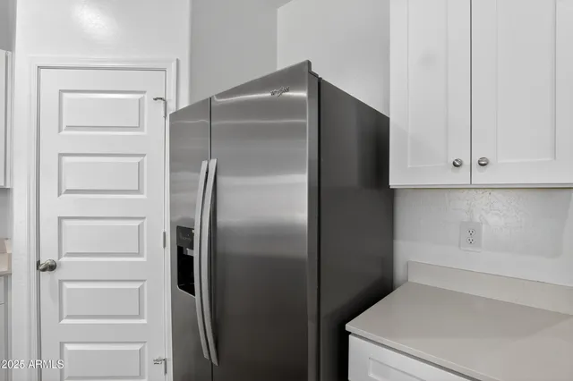 a kitchen with a refrigerator and cabinet
