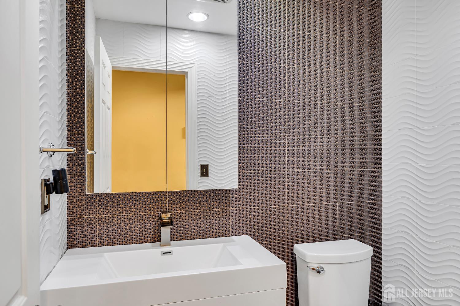 152 Redpine Loop Old Bridge, NJ 08857 - Photo 12 of 27 a bathroom with a sink a toilet and mirror