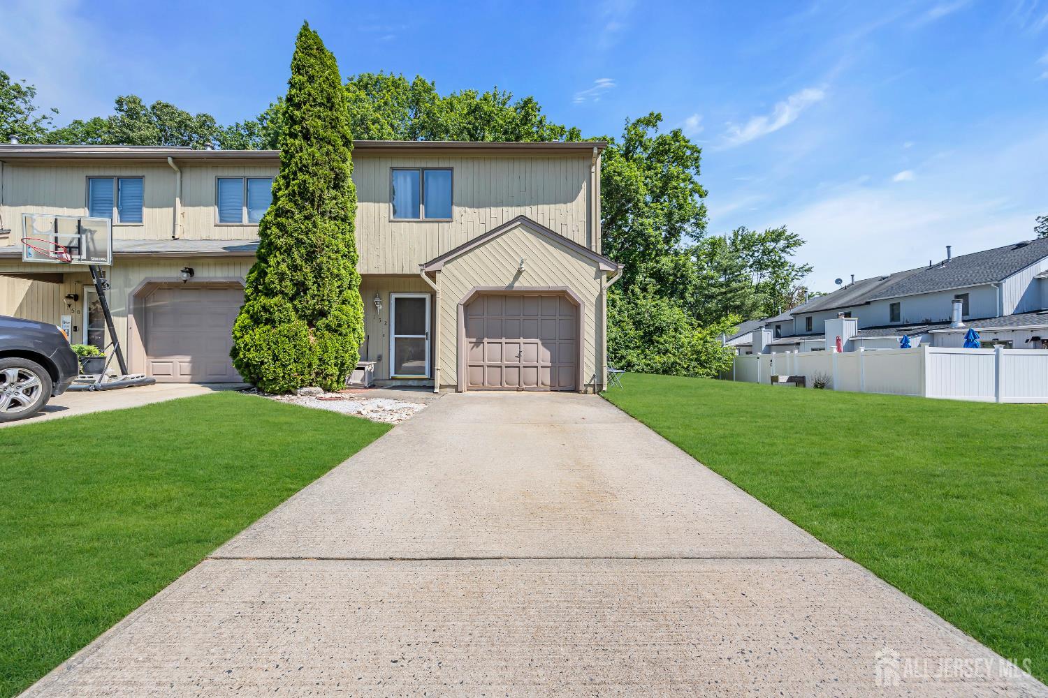 152 Redpine Loop Old Bridge, NJ 08857 - Photo 2 of 27 a front view of a house with a yard and garage