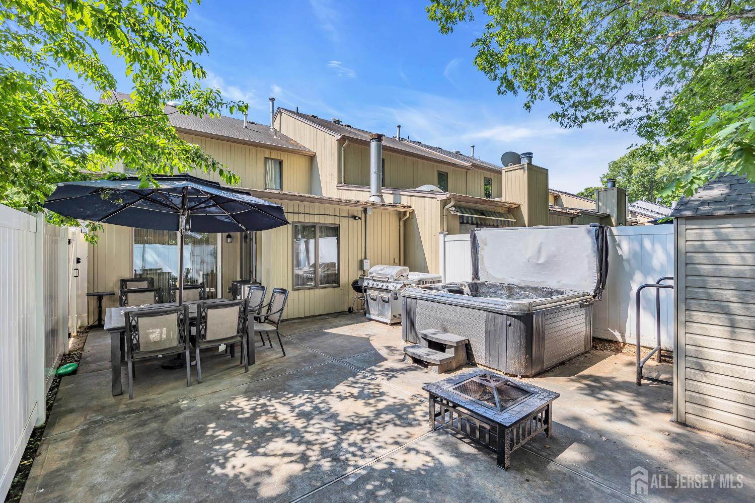 152 Redpine Loop Old Bridge, NJ 08857 - Photo 22 of 27 a view of a dinning tables and chairs in a patio