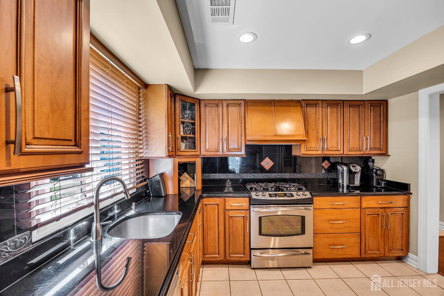 152 Redpine Loop Old Bridge, NJ 08857 - Photo 10 of 27 a kitchen with granite countertop a stove sink and cabinets