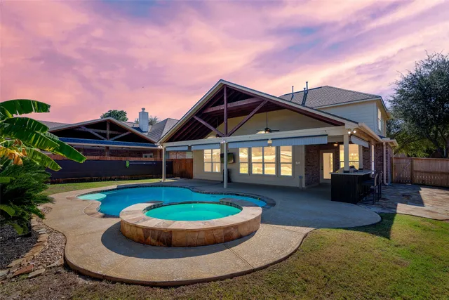 a view of a house with swimming pool and sitting area