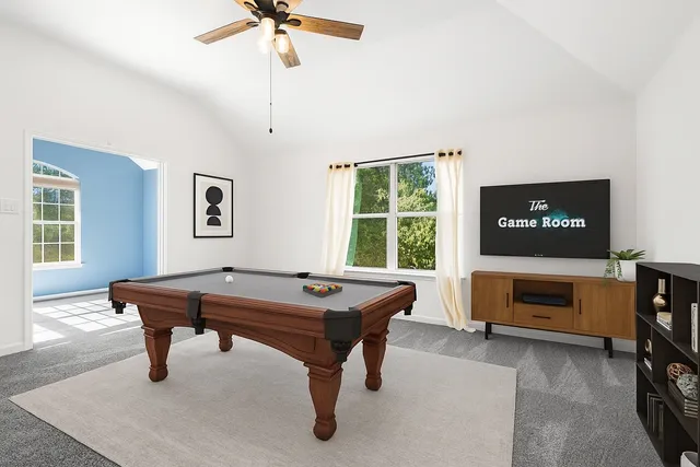 a room with pool table and windows