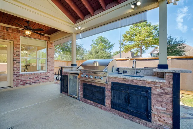 a open kitchen with stainless steel appliances granite countertop a stove a sink and a refrigerator
