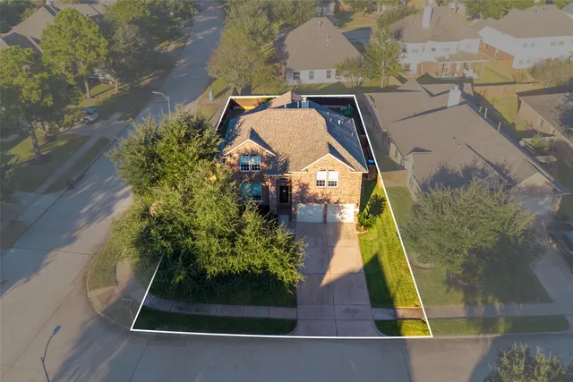 an aerial view of a house with a yard