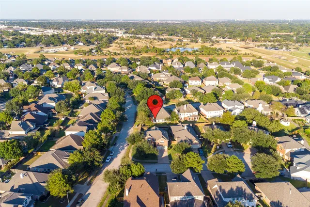 an aerial view of residential houses with outdoor space