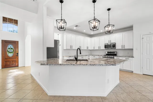 a view of a kitchen with a sink and refrigerator