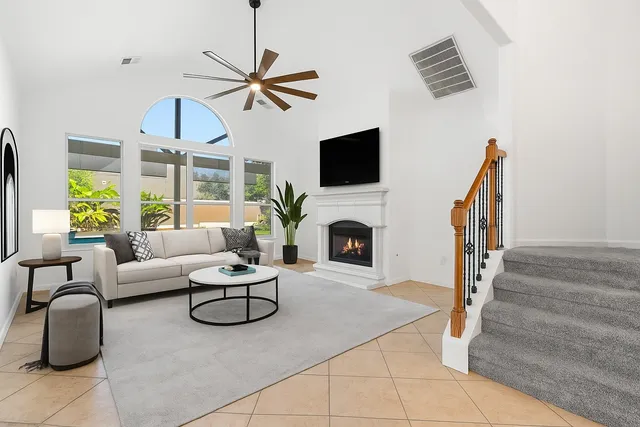 a living room with furniture a fireplace and a flat screen tv