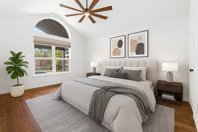 a spacious bedroom with a large bed and a window