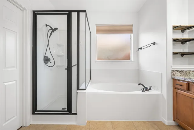 a bathroom with a bathtub and a shower