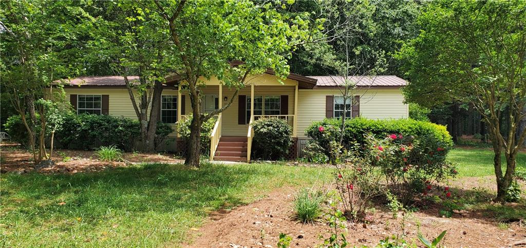 1501 Cole Springs Road Bishop, GA 30621 - Photo 1 of 1 a front view of a house with garden