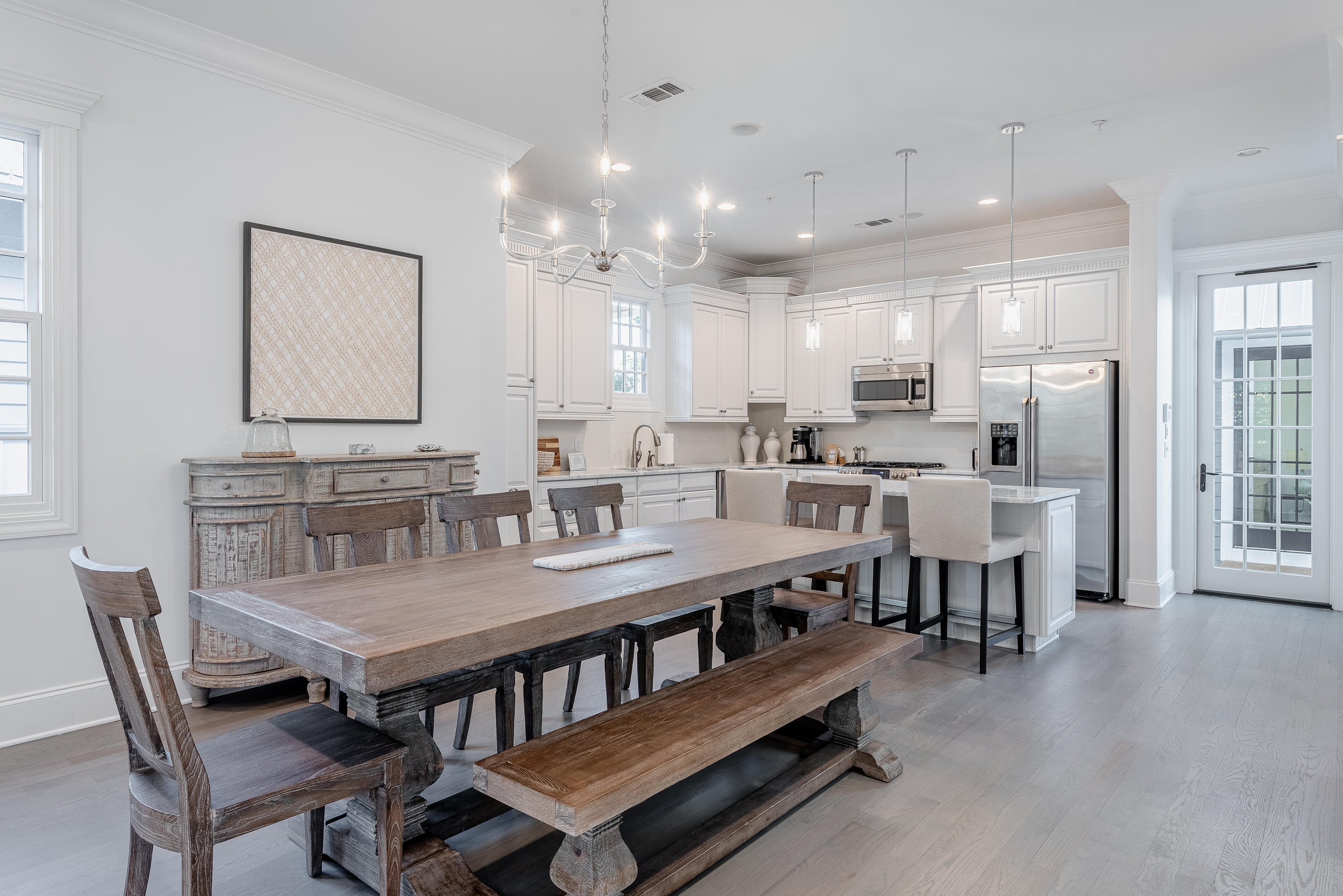 59 West Water Street Inlet Beach, FL 32461 - Photo 11 of 45 a dining room with stainless steel appliances kitchen island granite countertop a dining table chairs and view living room