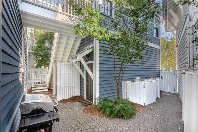 a backyard of a house with plants and tree