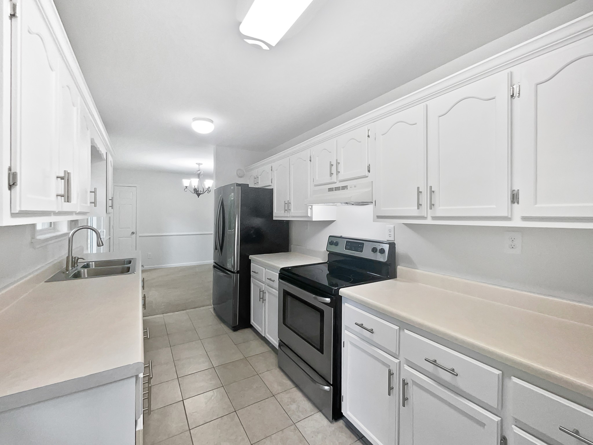 108 Nancy Avenue Pleasant View, TN 37146 - Photo 14 of 20 a kitchen with white cabinets and stainless steel appliances
