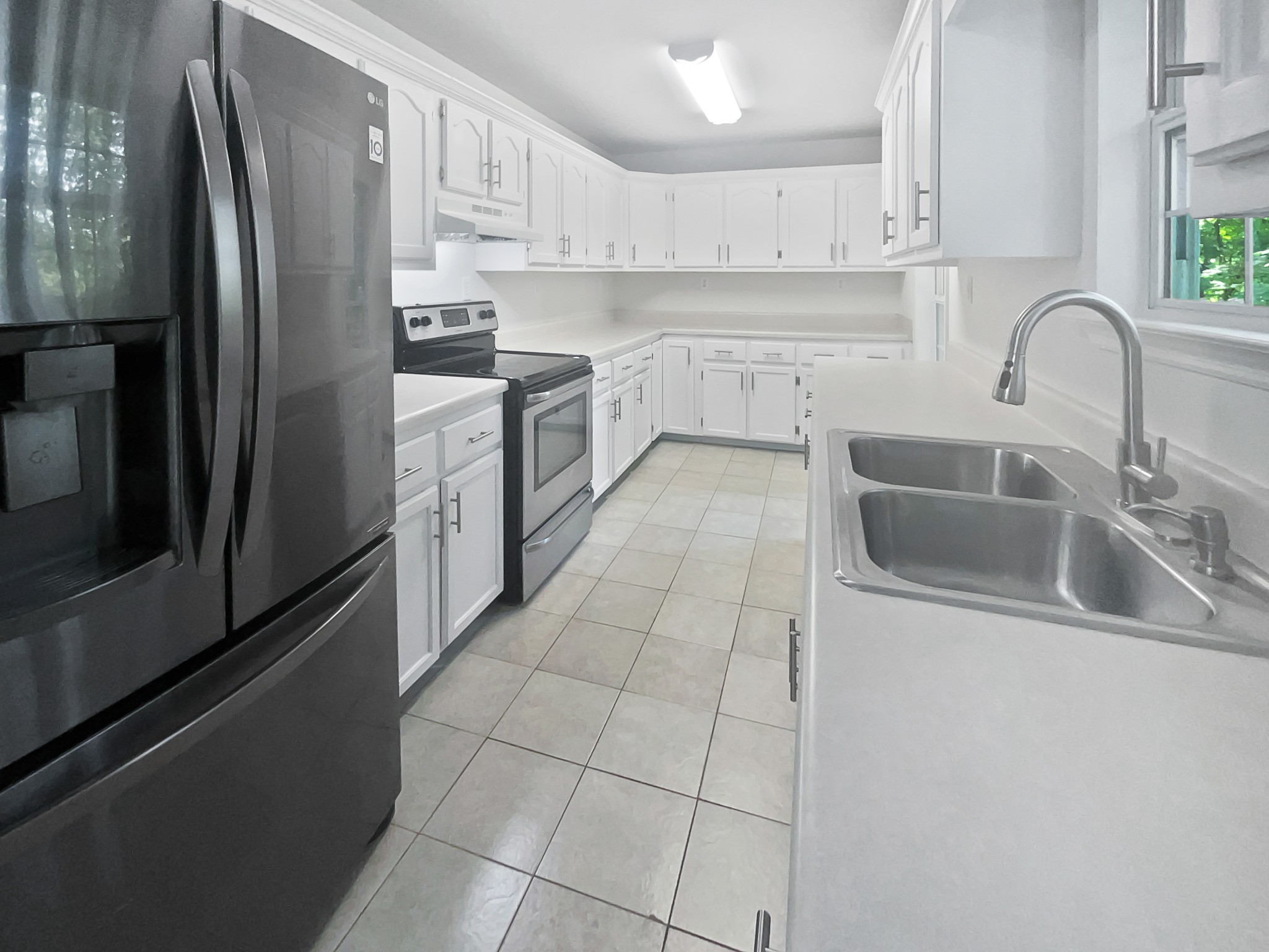 108 Nancy Avenue Pleasant View, TN 37146 - Photo 6 of 20 a kitchen with stainless steel appliances granite countertop a refrigerator sink and cabinets