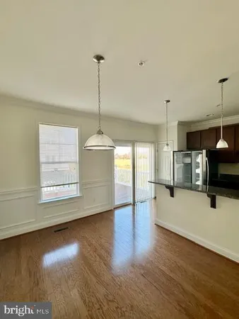 a view of kitchen with furniture and wooden floor