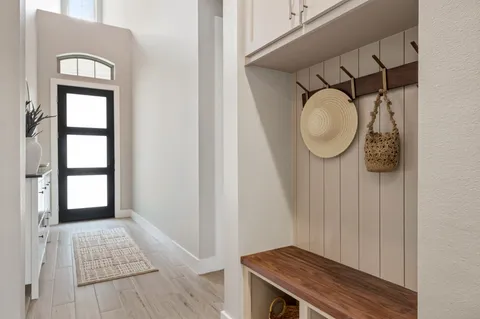 an open kitchen with wooden floor and stainless steel appliances