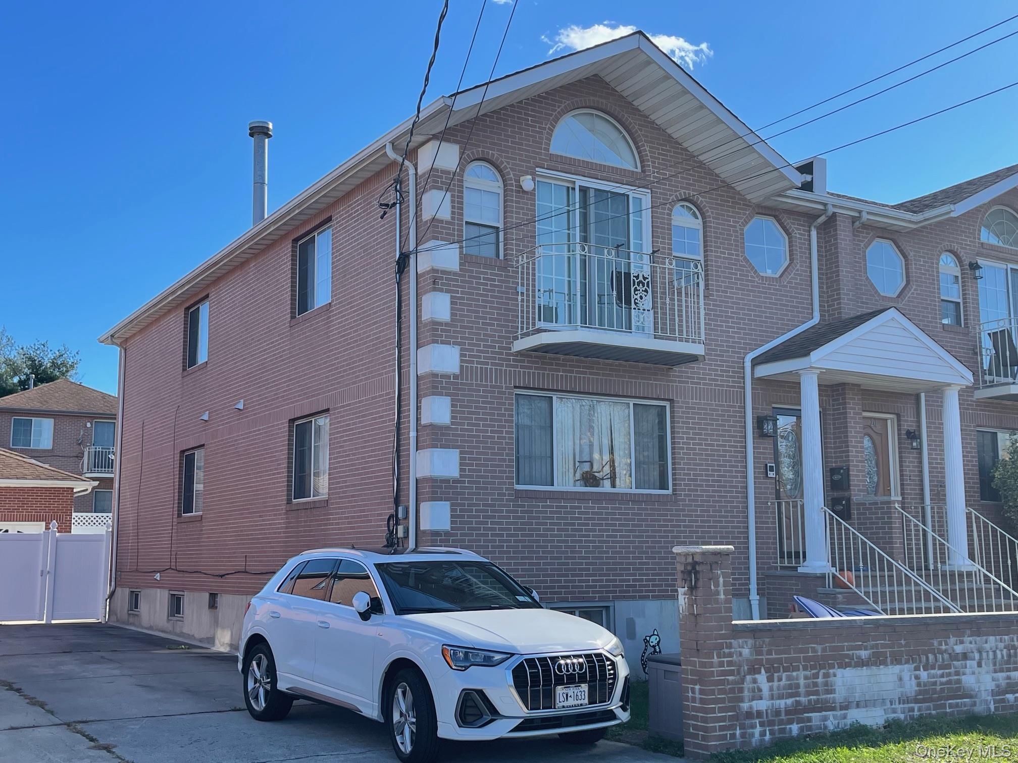a car parked in front of a brick house