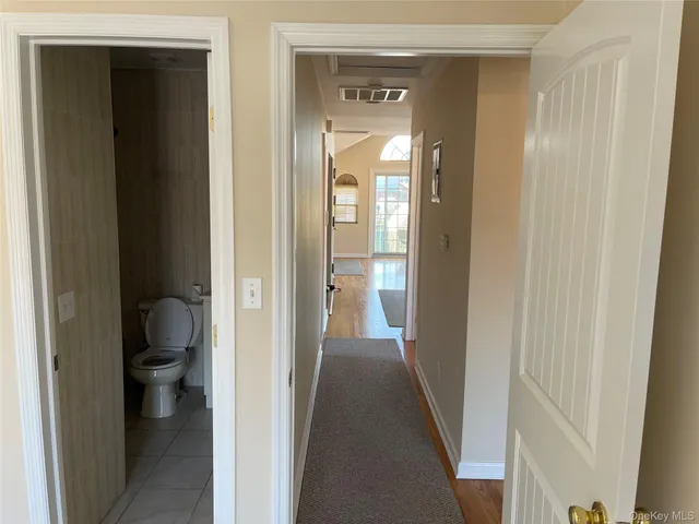 a view of a bathroom from a hallway with toilet