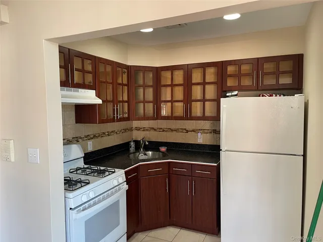 a kitchen with a stove and a refrigerator