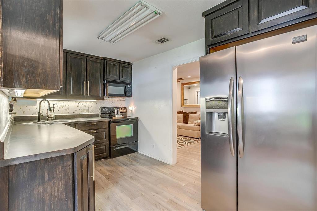 3147 Tin Top Road Weatherford, TX 76087 - Photo 11 of 40 a kitchen with stainless steel appliances granite countertop a refrigerator a sink and a stove