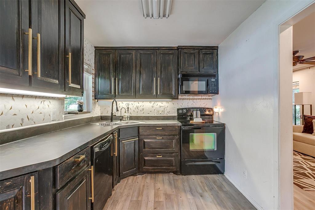 3147 Tin Top Road Weatherford, TX 76087 - Photo 12 of 40 a kitchen with a sink stove and cabinets