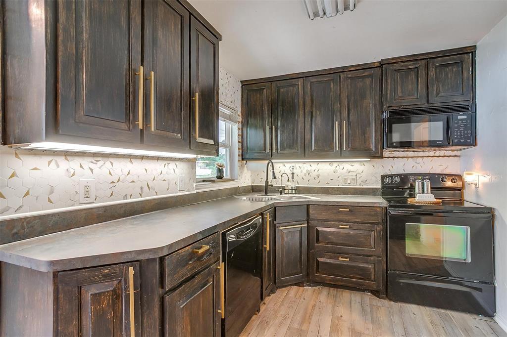 3147 Tin Top Road Weatherford, TX 76087 - Photo 14 of 40 a kitchen with a sink stove and microwave