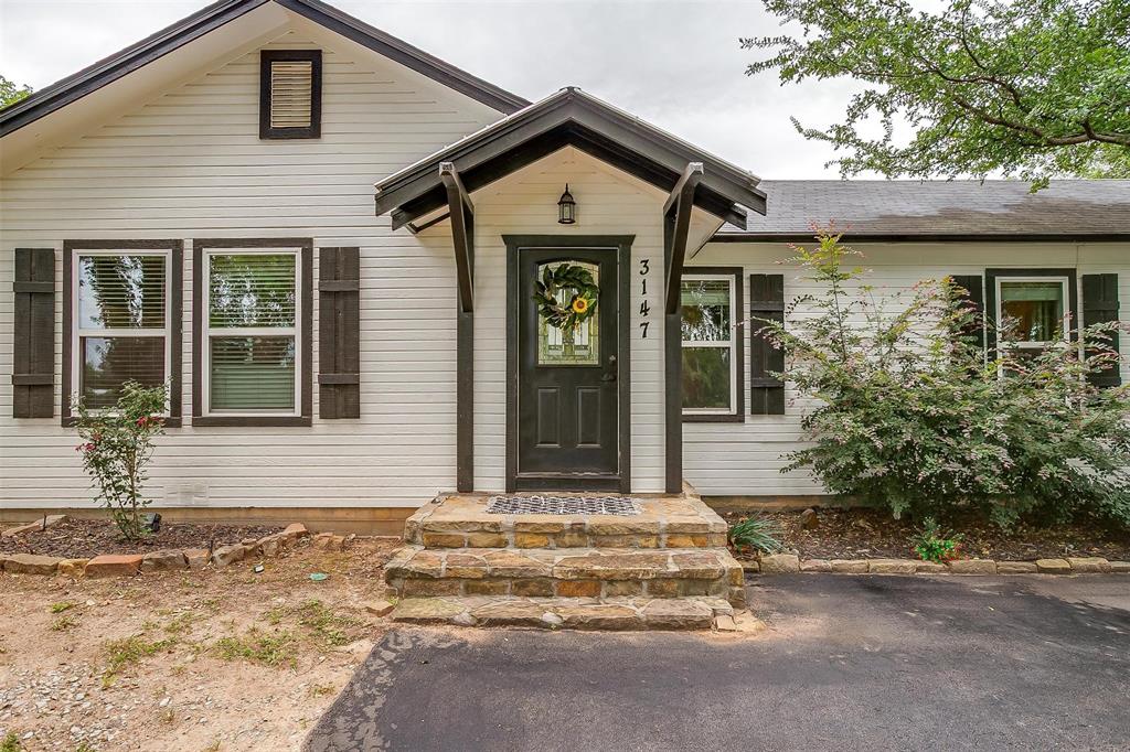 3147 Tin Top Road Weatherford, TX 76087 - Photo 2 of 40 a front view of a house with a garden
