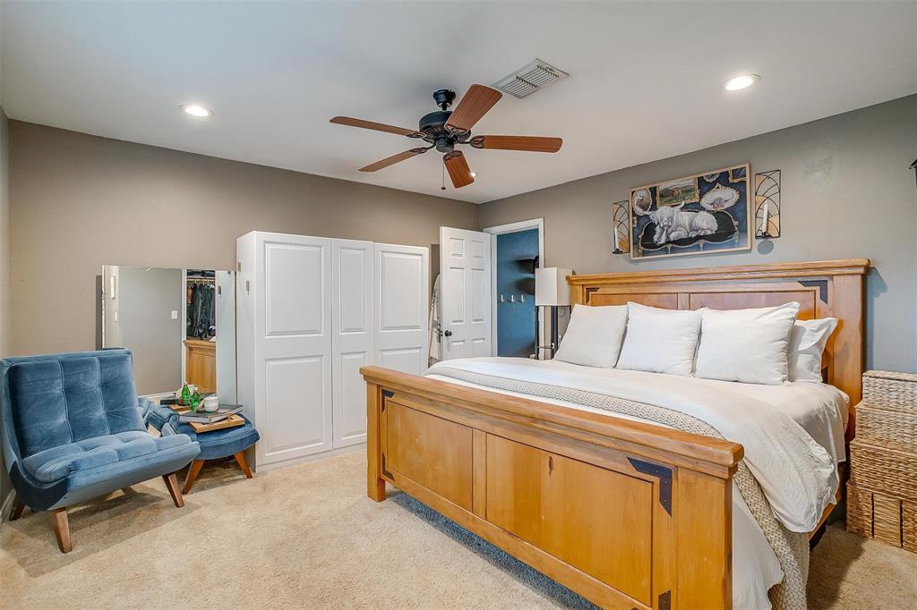 3147 Tin Top Road Weatherford, TX 76087 - Photo 22 of 40 a bedroom with a bed a couch and a chandelier