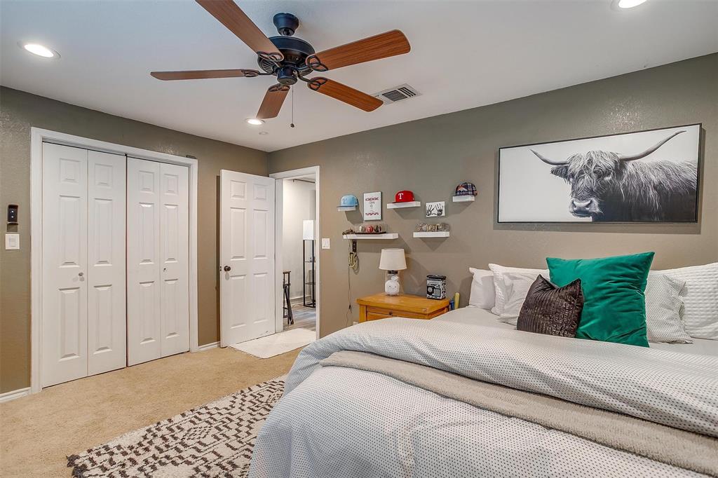 3147 Tin Top Road Weatherford, TX 76087 - Photo 23 of 40 a bedroom with a bed and a chandelier