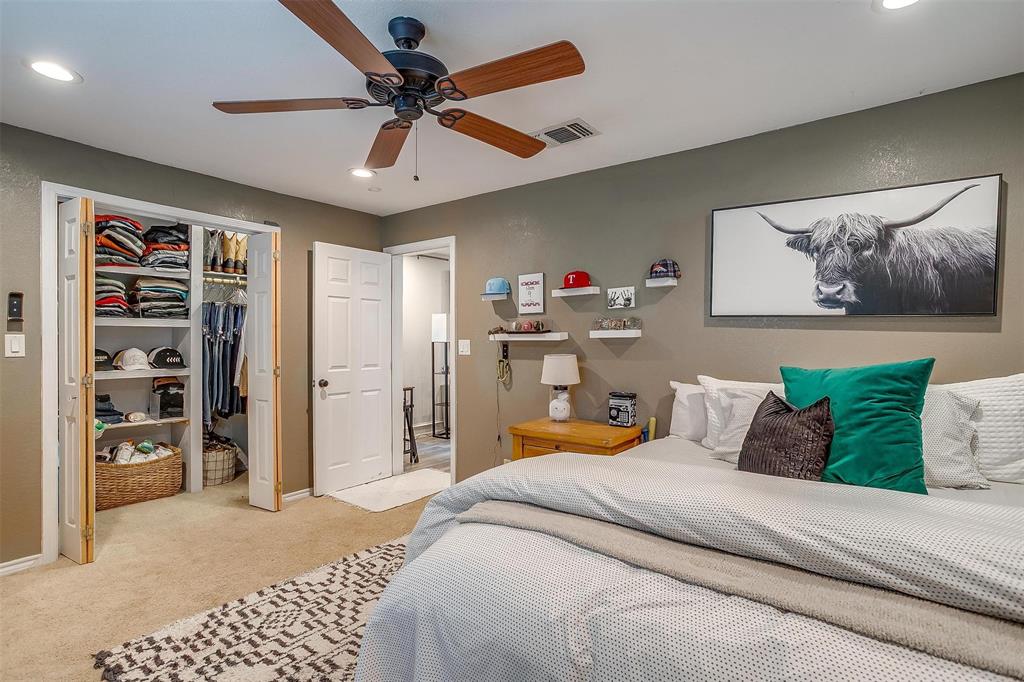 3147 Tin Top Road Weatherford, TX 76087 - Photo 24 of 40 a bedroom with a bed and a book shelf