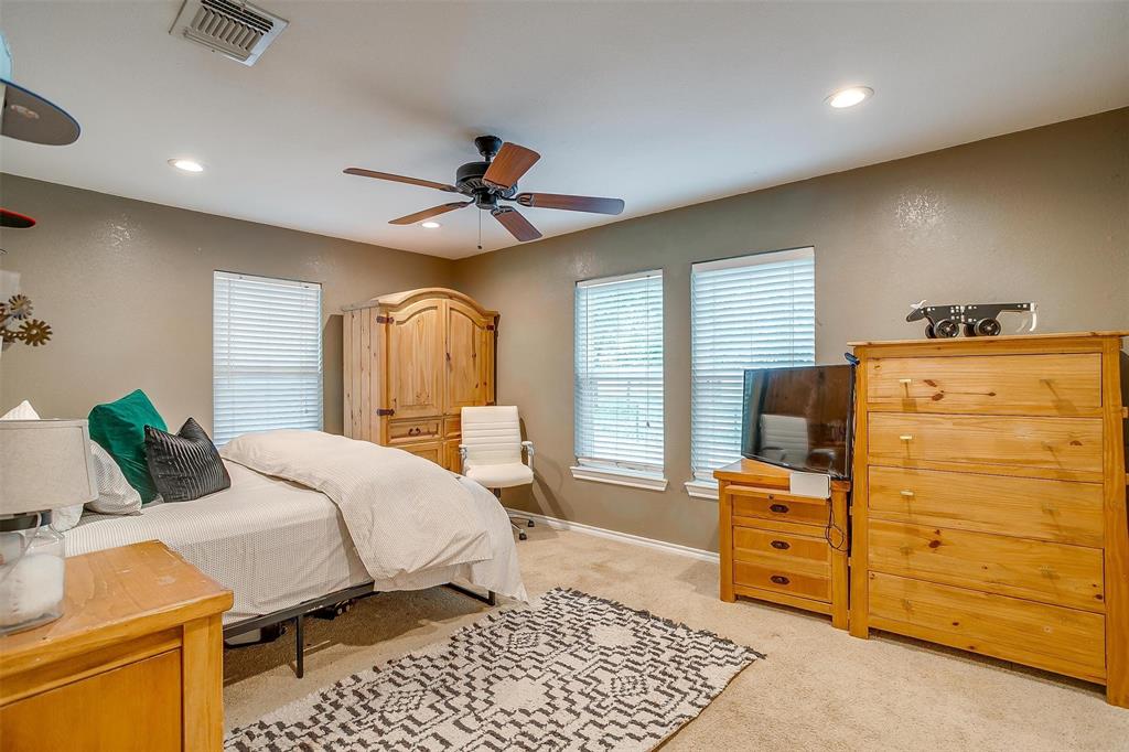 3147 Tin Top Road Weatherford, TX 76087 - Photo 25 of 40 a bedroom with a bed and wooden floor