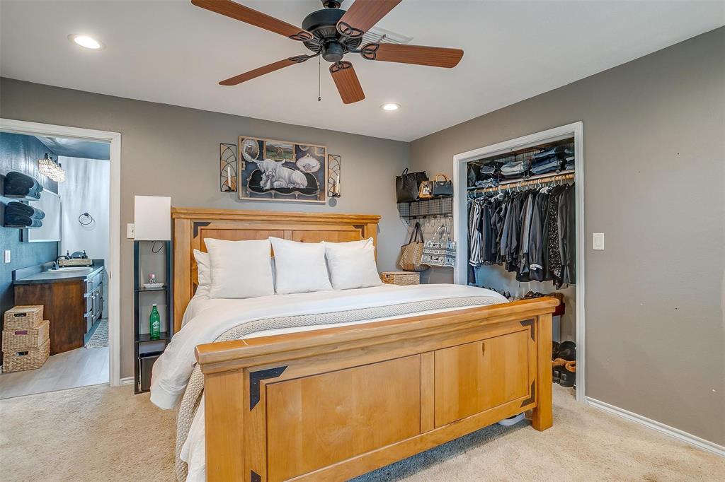 3147 Tin Top Road Weatherford, TX 76087 - Photo 30 of 40 a bedroom with a bed and a chandelier