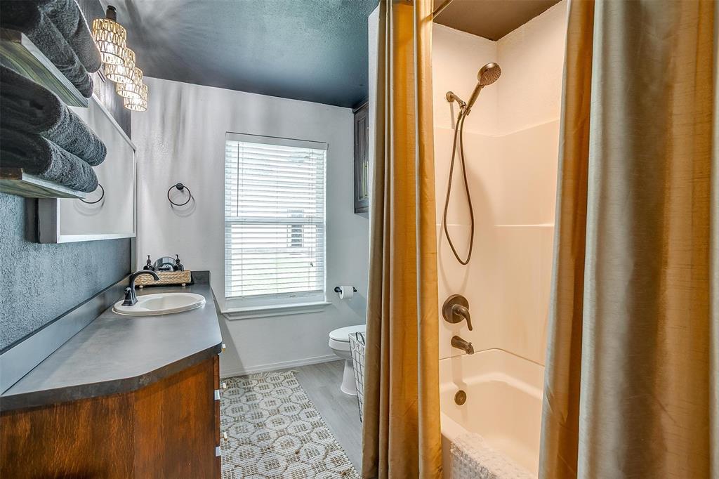 3147 Tin Top Road Weatherford, TX 76087 - Photo 35 of 40 a bathroom with a granite countertop sink a mirror and a shower