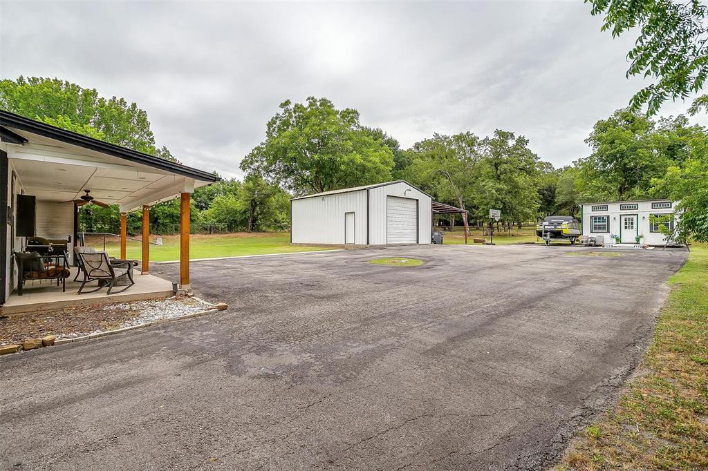 3147 Tin Top Road Weatherford, TX 76087 - Photo 38 of 40 a house with trees in front of it
