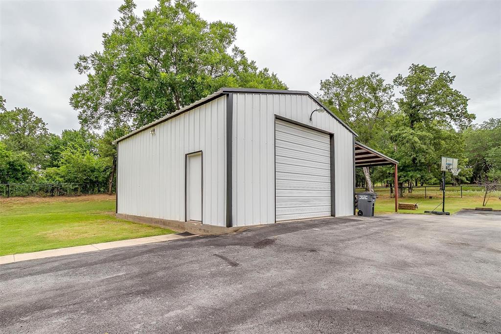 3147 Tin Top Road Weatherford, TX 76087 - Photo 39 of 40 a view of a house with a backyard and a small yard