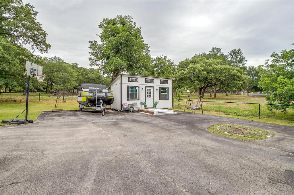 3147 Tin Top Road Weatherford, TX 76087 - Photo 40 of 40 a view of a house with swimming pool and a car parked on road