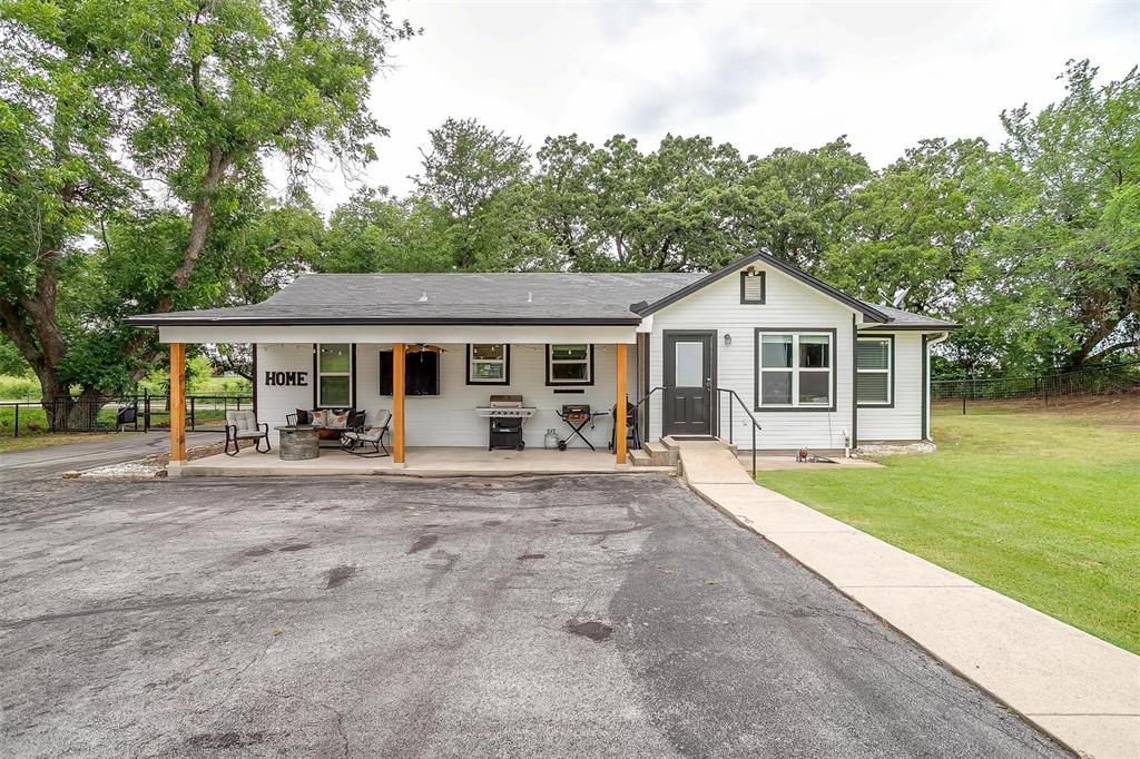 3147 Tin Top Road Weatherford, TX 76087 - Photo 4 of 40 a front view of a house with a garden