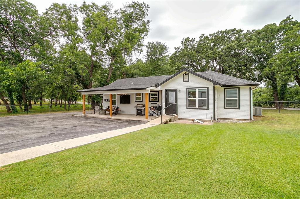3147 Tin Top Road Weatherford, TX 76087 - Photo 5 of 40 a front view of a house with swimming pool and porch