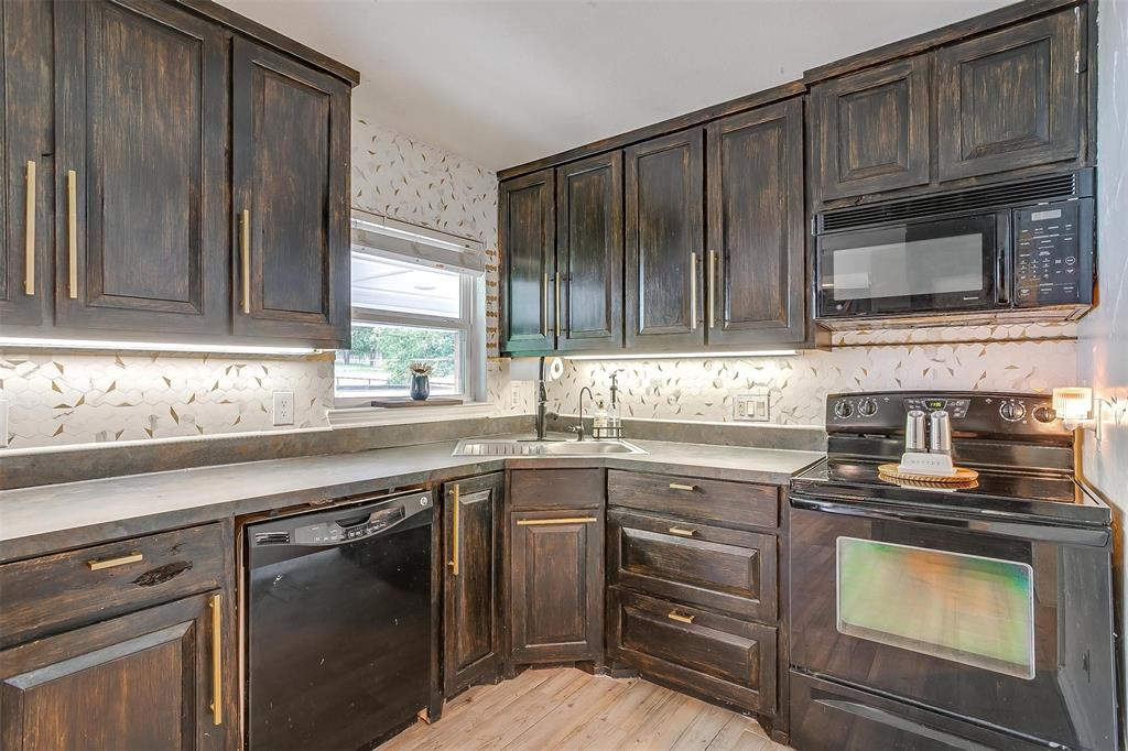 3147 Tin Top Road Weatherford, TX 76087 - Photo 10 of 40 a kitchen with a sink stove and microwave