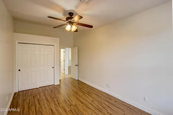 a view of empty room with wooden floor