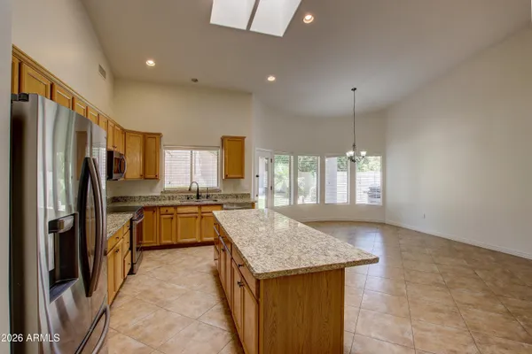 a kitchen with refrigerator a stove and a sink
