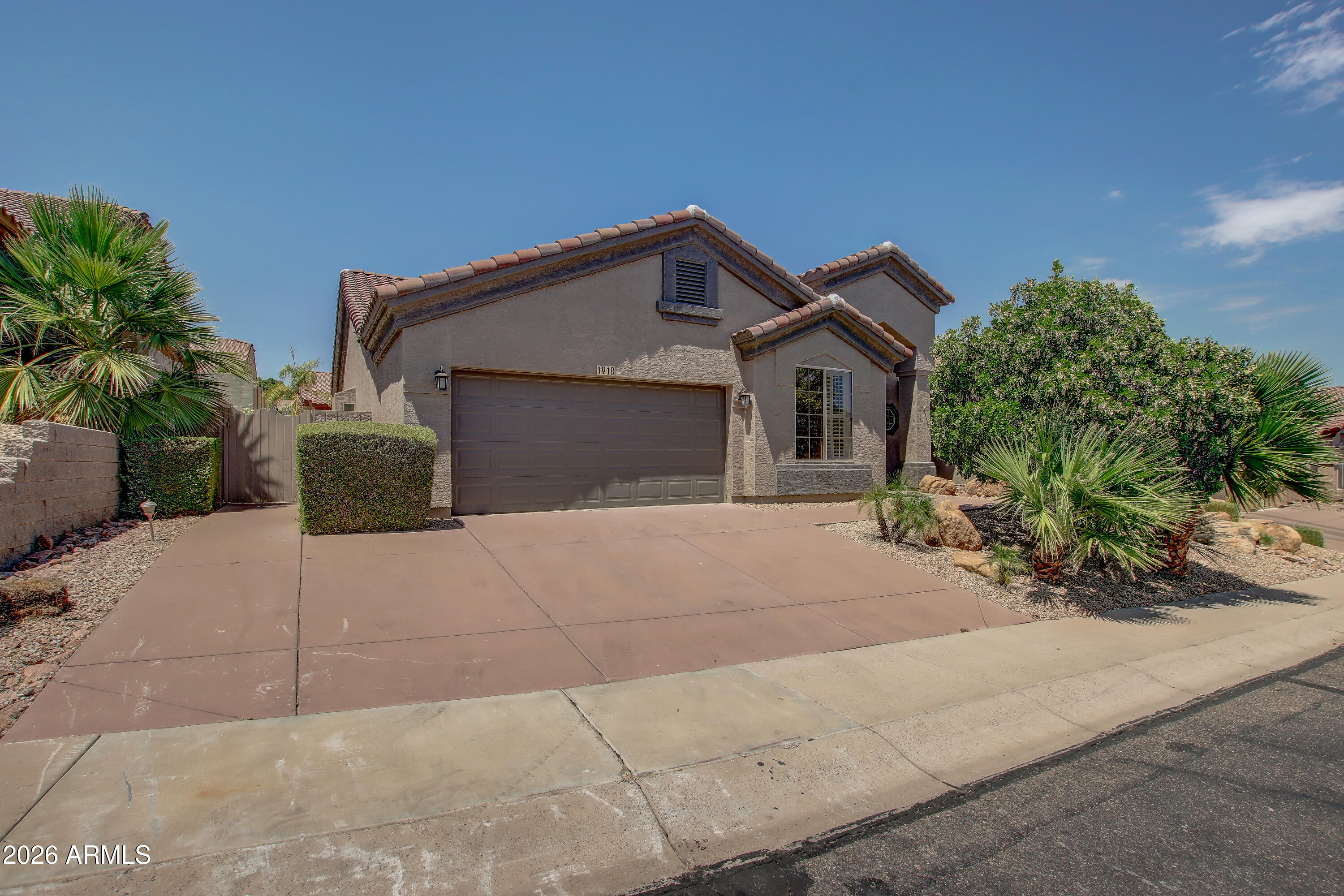 1918 East Marilyn Road Phoenix, AZ 85022 - Photo 2 of 43 a front view of a house with a yard and a garage