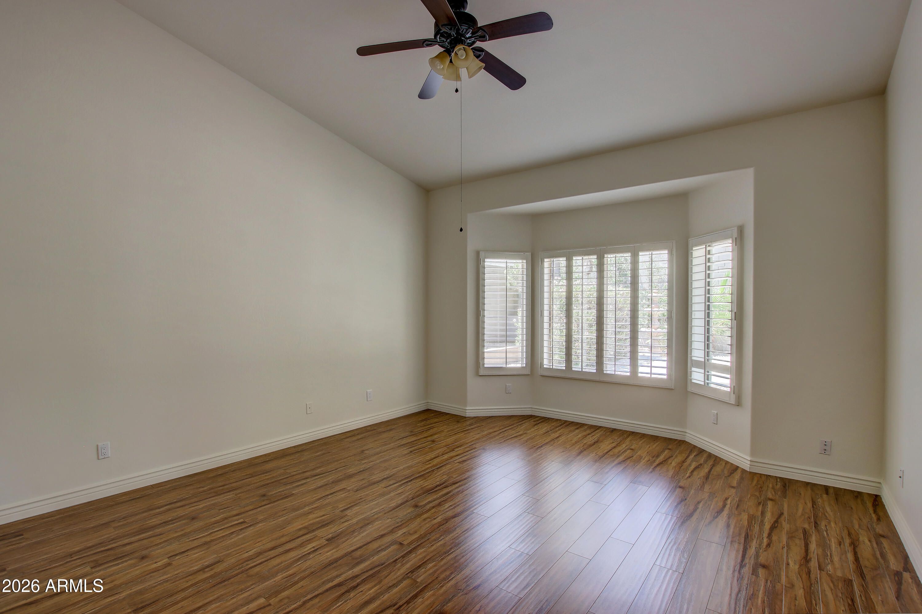 1918 East Marilyn Road Phoenix, AZ 85022 - Photo 32 of 43 a view of an empty room with wooden floor and a window