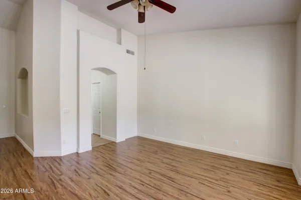 a view of empty room with wooden floor