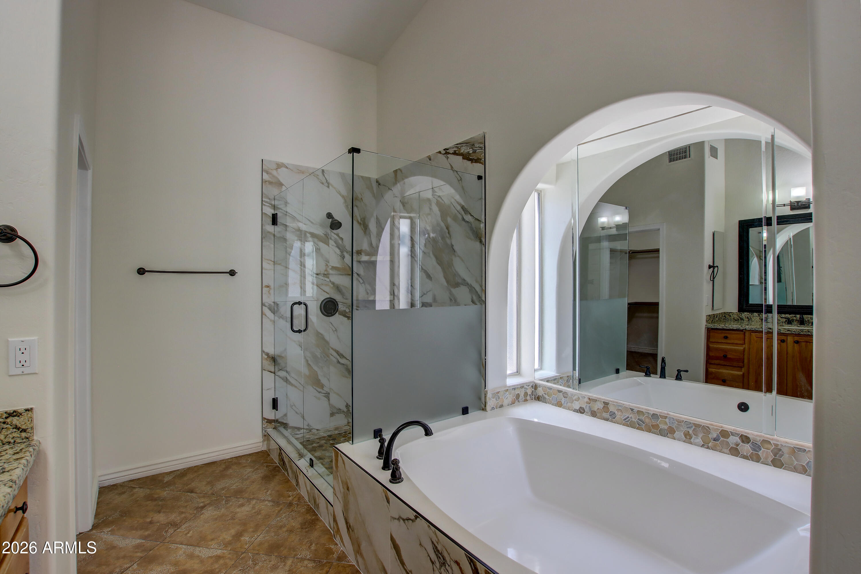 1918 East Marilyn Road Phoenix, AZ 85022 - Photo 37 of 43 a bathroom with a tub a sink and a mirror
