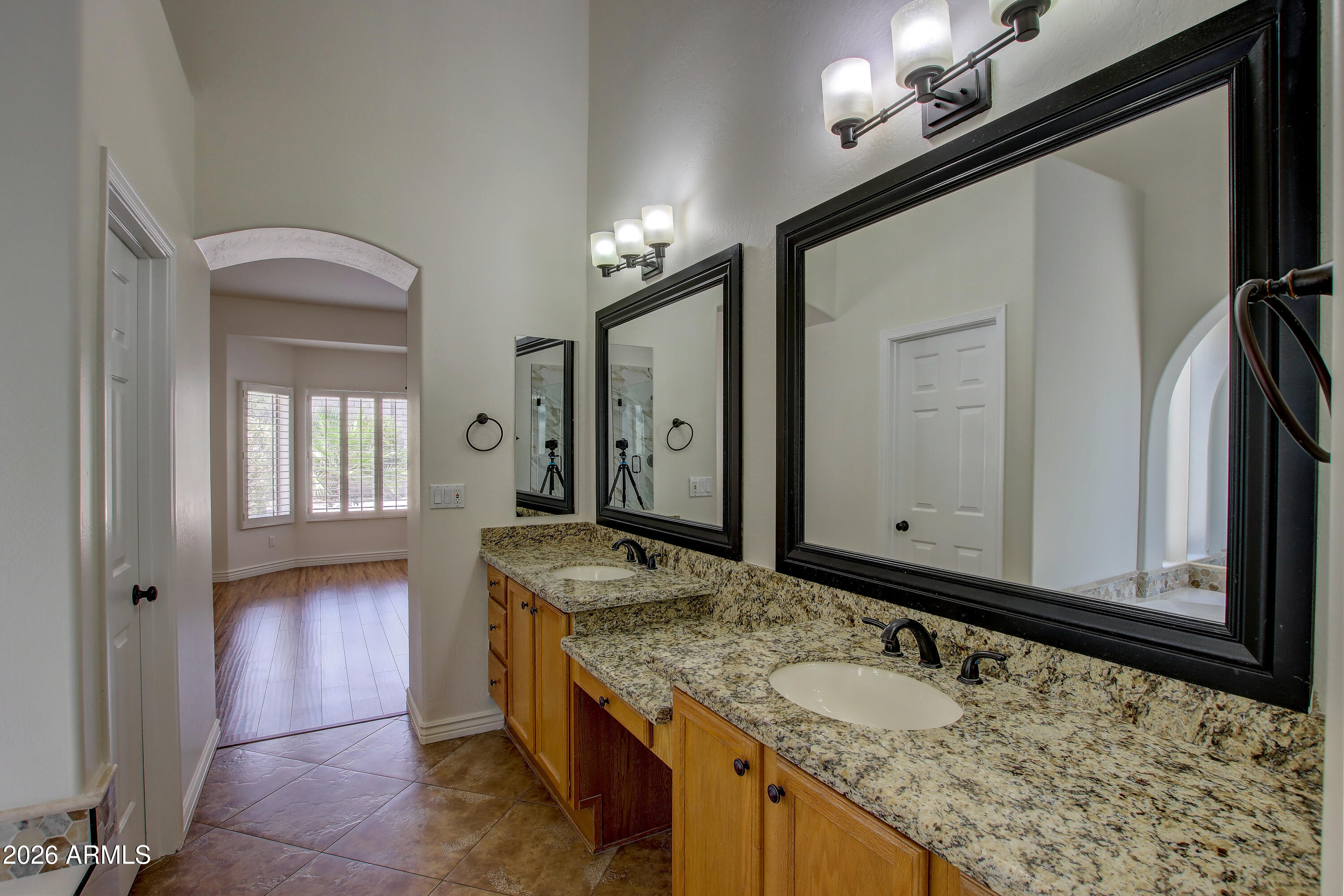 1918 East Marilyn Road Phoenix, AZ 85022 - Photo 38 of 43 a bathroom with a granite countertop sink and a mirror